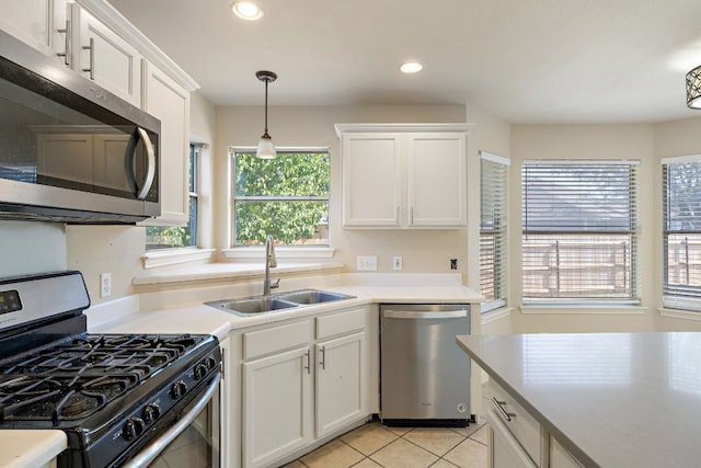 110 Dogwood Dr, Georgetown, TX 78626 - kitchen with light tile patterned floors, white cabinetry, a sink, and appliances with stainless steel finishes