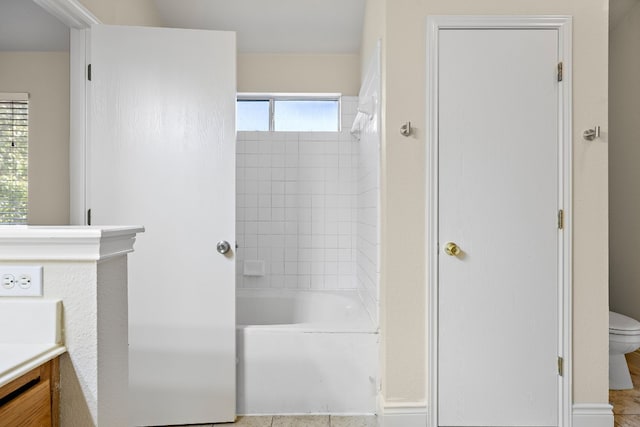 bathroom featuring washtub / shower combination, toilet, and vanity