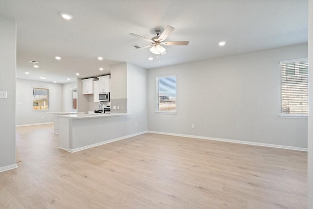 interior space featuring light hardwood / wood-style flooring, ceiling fan, a healthy amount of sunlight, and sink