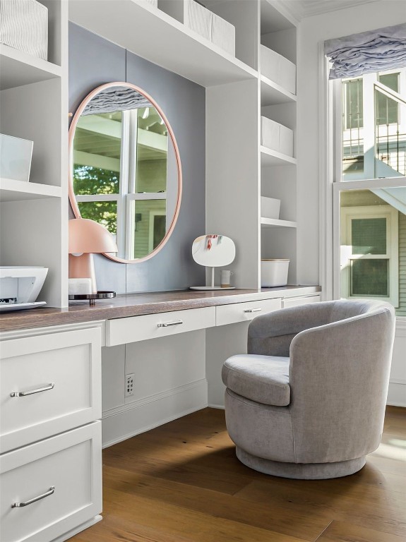 office area featuring built in shelves and wood finished floors
