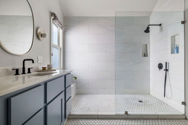 bathroom featuring tile patterned floors, vanity, and tiled shower
