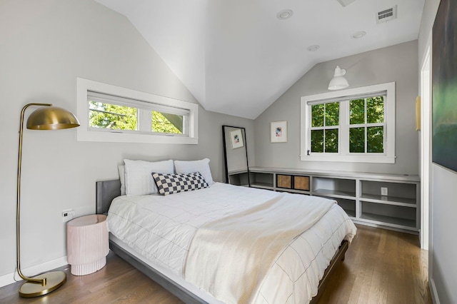bedroom featuring wood finished floors, multiple windows, and visible vents