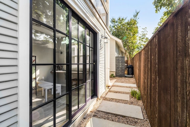 view of side of home featuring fence