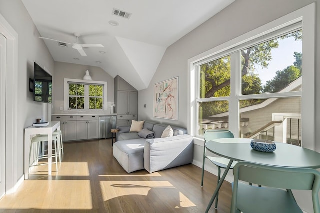 sitting room featuring lofted ceiling, wood finished floors, visible vents, and a ceiling fan