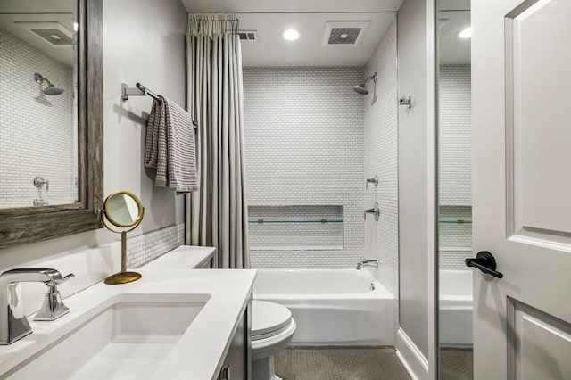 bathroom with tile patterned floors, toilet, visible vents, shower / bath combination, and vanity