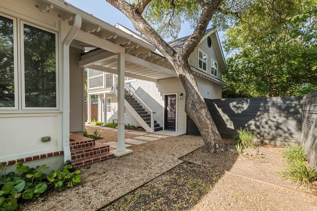 exterior space with fence and stairs