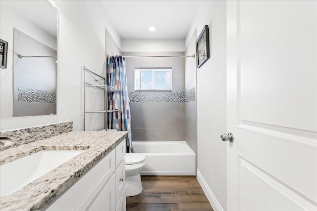 full bathroom with vanity, hardwood / wood-style flooring, toilet, and shower / bath combo with shower curtain