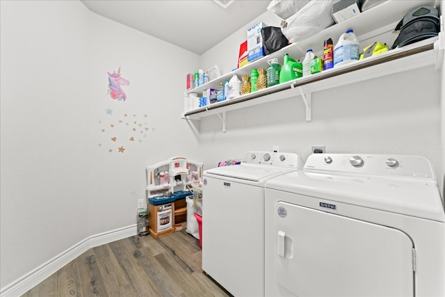 laundry area with hardwood / wood-style flooring and washer and dryer