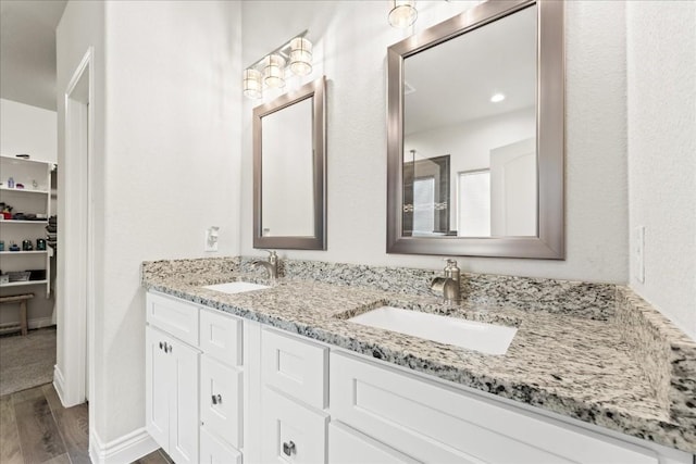 113 Tonkawa Ln, Paige, TX 78659 - full bath with double vanity and wood finished floors
