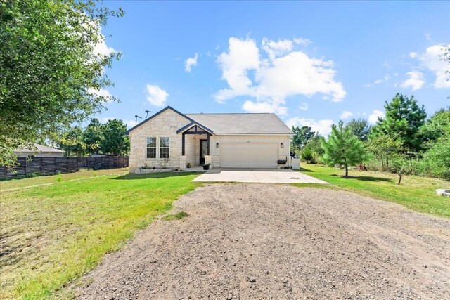 view of front of property featuring a garage and a front lawn