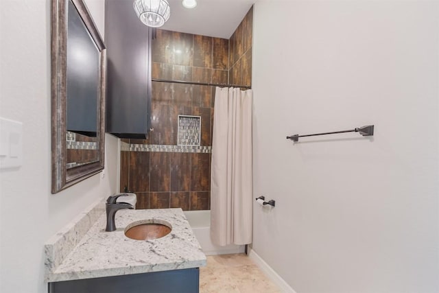 bathroom with shower / tub combo, baseboards, and vanity