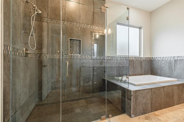 full bath featuring a shower stall and a bath