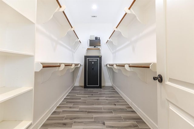 spacious closet featuring wood finish floors