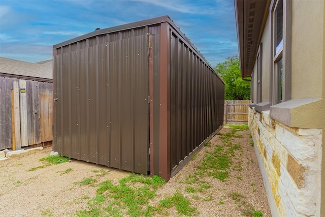 view of outdoor structure featuring a fenced backyard