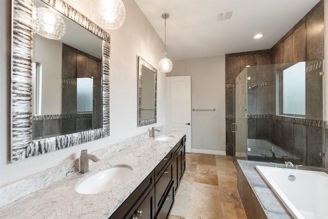 full bathroom featuring a garden tub, a stall shower, a sink, and baseboards