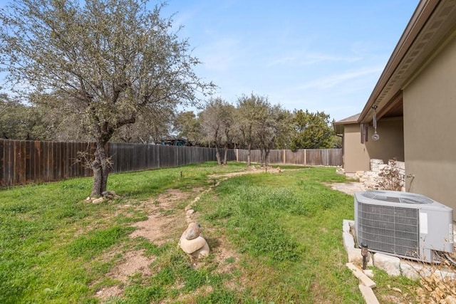 view of yard with a fenced backyard and cooling unit