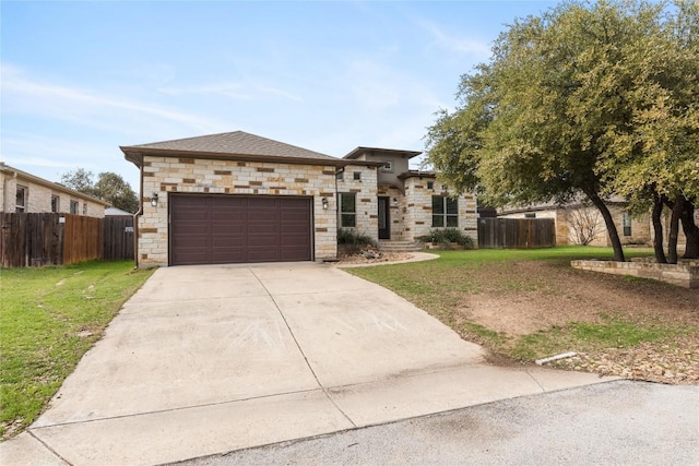 view of front of house with a garage, driveway, a front yard, and fence