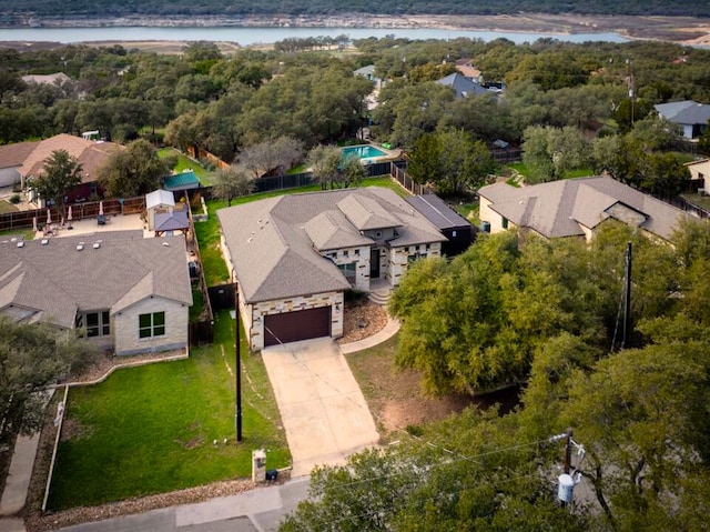 drone / aerial view featuring a water view and a residential view