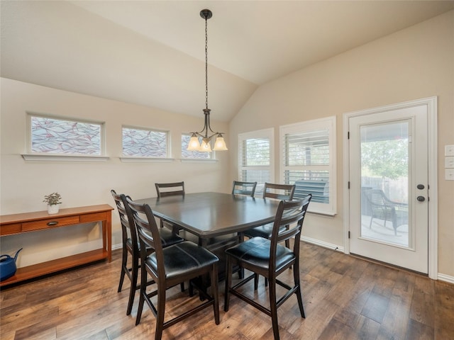 dining room with wood-type flooring, a notable chandelier, and vaulted ceiling