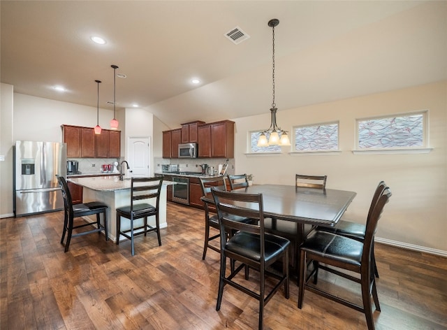 dining area with an inviting chandelier, lofted ceiling, dark hardwood / wood-style floors, and sink