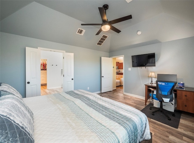 bedroom with ceiling fan, lofted ceiling, and light wood-type flooring