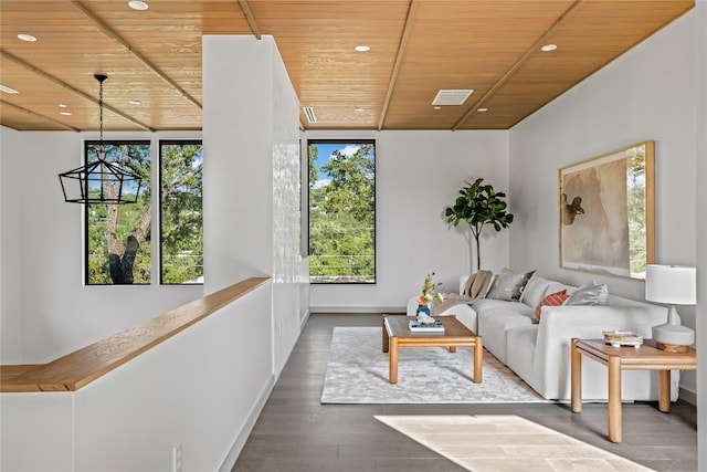 living room featuring a wealth of natural light, a chandelier, wood-type flooring, and wooden ceiling