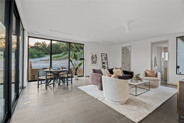 living room with ceiling fan, light wood-type flooring, and floor to ceiling windows