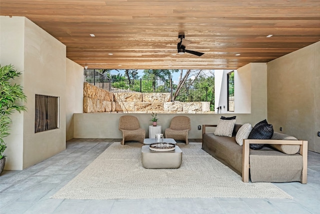 view of patio / terrace with ceiling fan and a fire pit