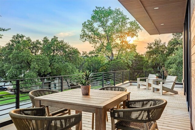 2400 Trail Of The Madrones, Austin, TX 78746 - balcony at dusk featuring view of wooded area