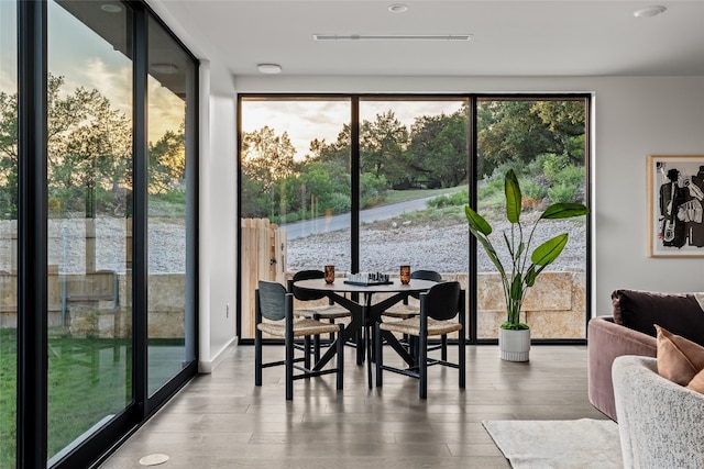 dining space featuring wood-type flooring