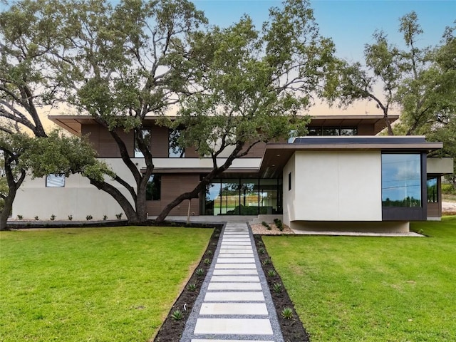 2400 Trail Of The Madrones, Austin, TX 78746 - rear view of property with a yard and stucco siding