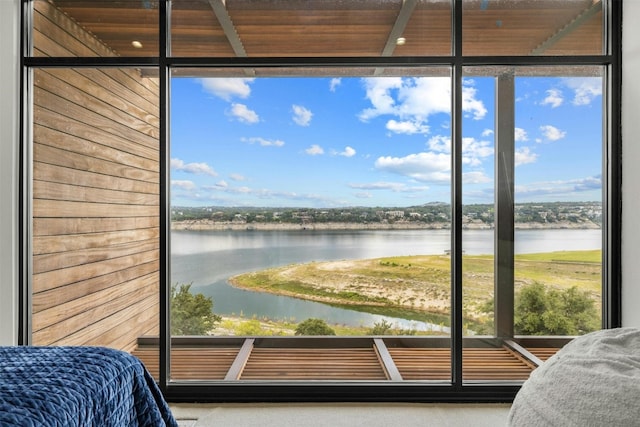 interior space featuring a water view and a wall of windows