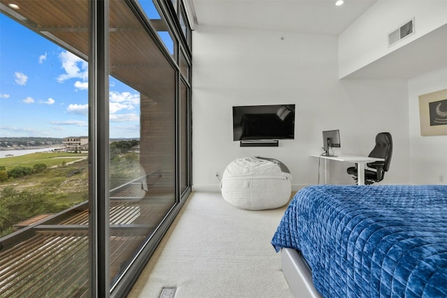 carpeted bedroom featuring recessed lighting, visible vents, a water view, and baseboards