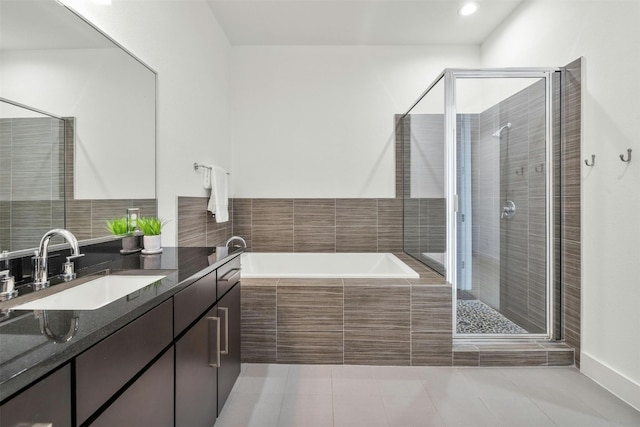 bathroom featuring tile patterned floors, shower with separate bathtub, and vanity