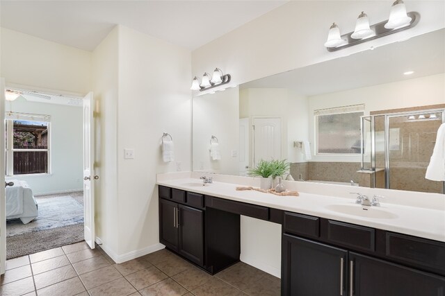 bathroom with vanity, a shower with shower door, and tile patterned floors