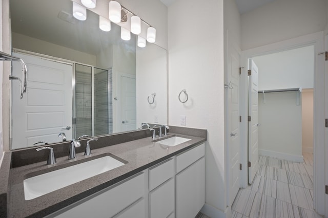 bathroom with walk in shower and vanity