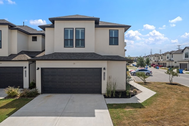 view of front of house featuring a garage and a front lawn