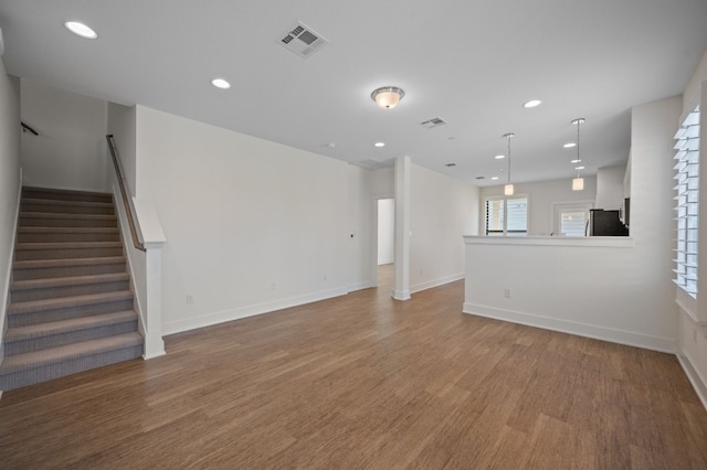 unfurnished living room featuring wood-type flooring