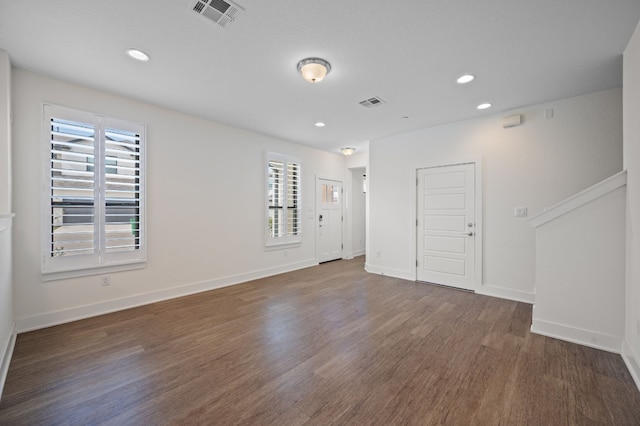 empty room with dark hardwood / wood-style flooring