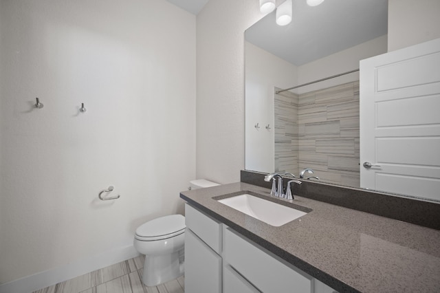 bathroom with walk in shower, tile patterned flooring, vanity, and toilet