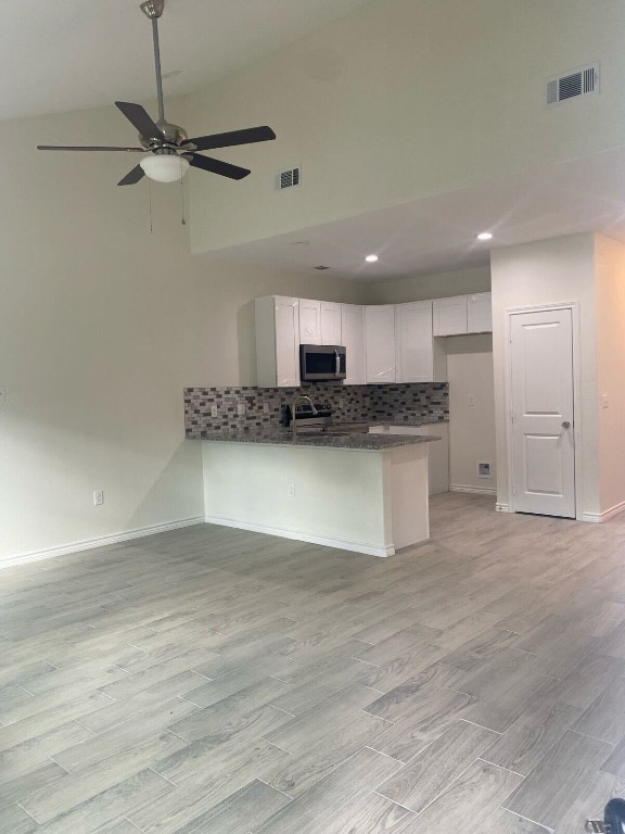 kitchen featuring ceiling fan, white cabinets, light hardwood / wood-style floors, and kitchen peninsula