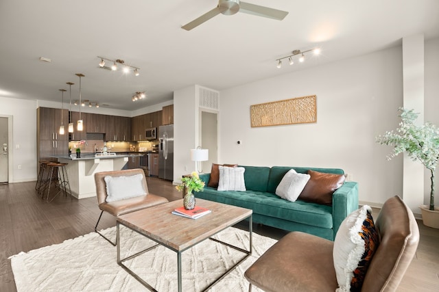 living room with light wood-type flooring and ceiling fan