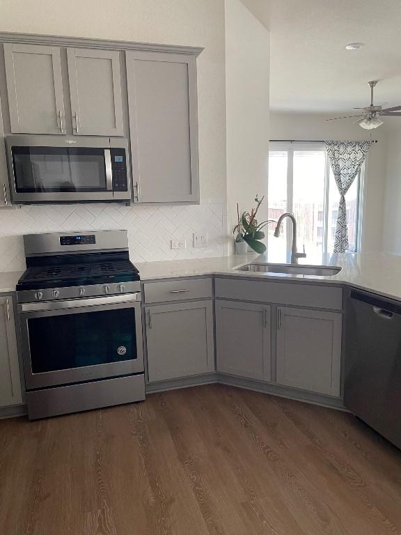 2421 Rosette Ln, Leander, TX 78641 - kitchen featuring appliances with stainless steel finishes, gray cabinets, and light countertops
