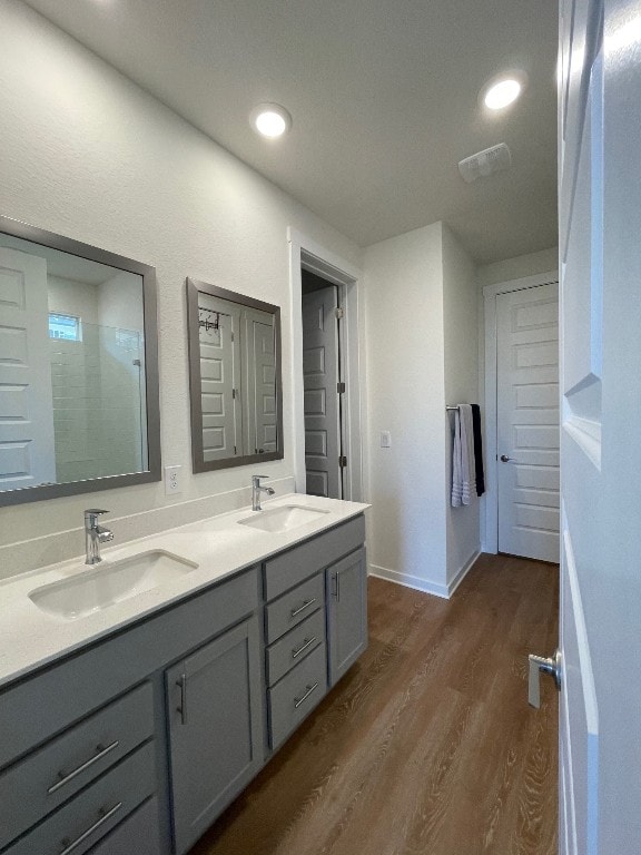 bathroom with vanity, hardwood / wood-style floors, and an enclosed shower