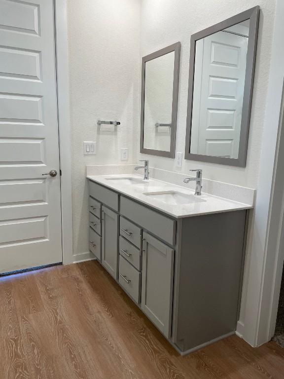 2421 Rosette Ln, Leander, TX 78641 - full bath featuring wood finished floors and double vanity