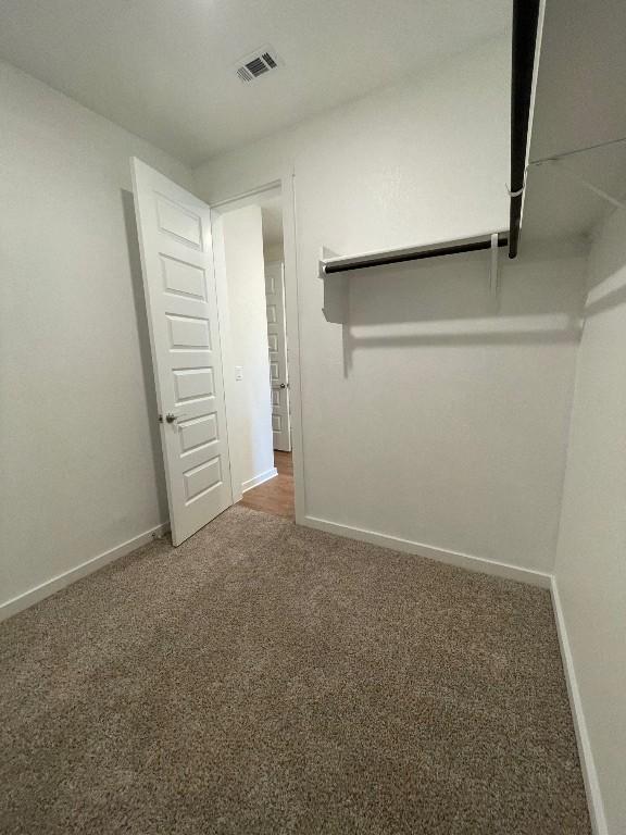 2421 Rosette Ln, Leander, TX 78641 - unfurnished bedroom with carpet flooring and baseboards