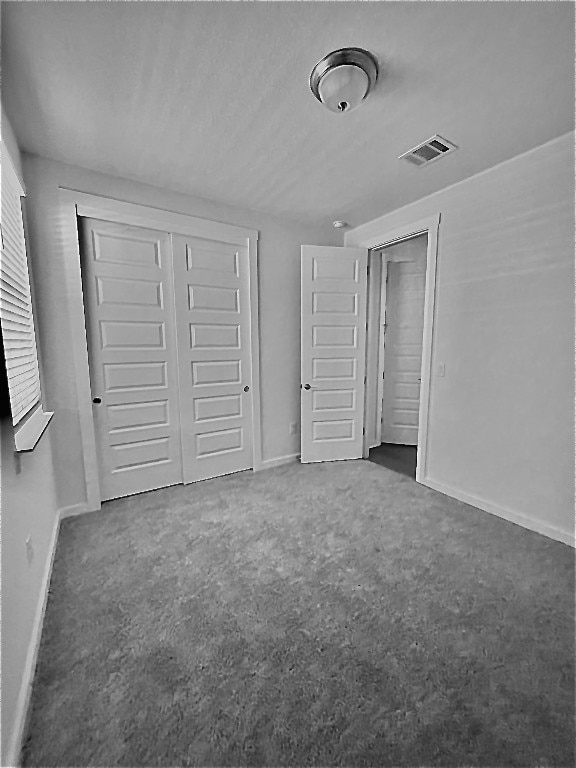 unfurnished bedroom featuring dark carpet