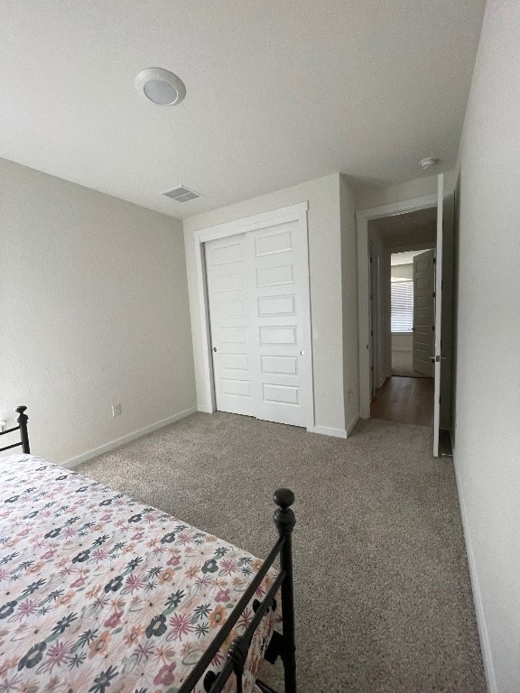 unfurnished bedroom with a closet, carpet flooring, and a textured ceiling