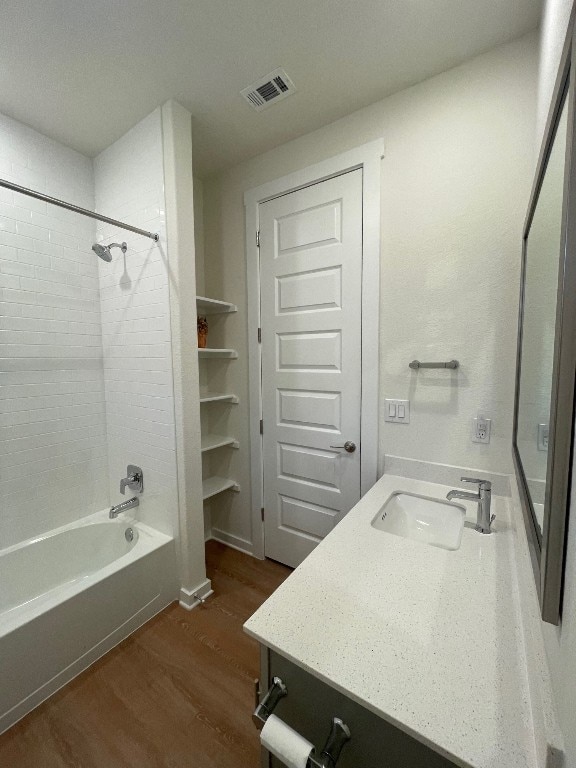 bathroom featuring vanity, shower / bathtub combination, and hardwood / wood-style flooring