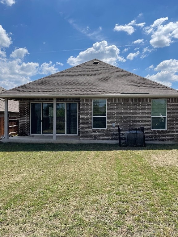 back of house with a yard and a patio